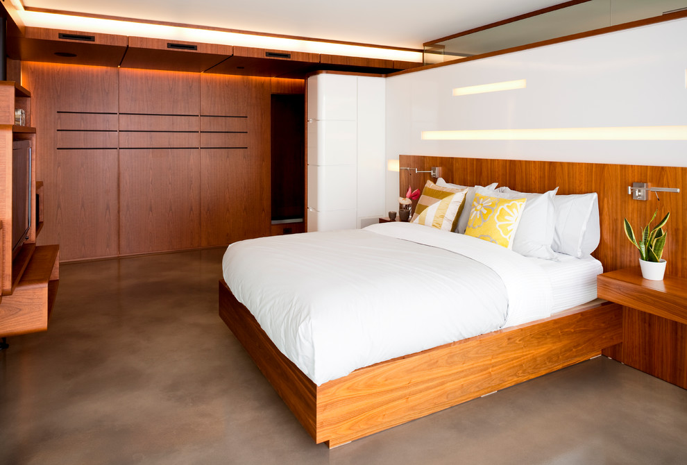 Photo of a contemporary master bedroom in Vancouver with white walls and concrete flooring.