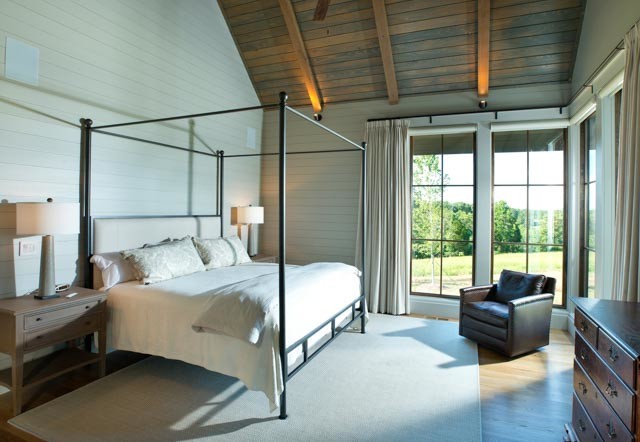 Photo of a medium sized rural master bedroom in Nashville with white walls, light hardwood flooring, no fireplace and beige floors.