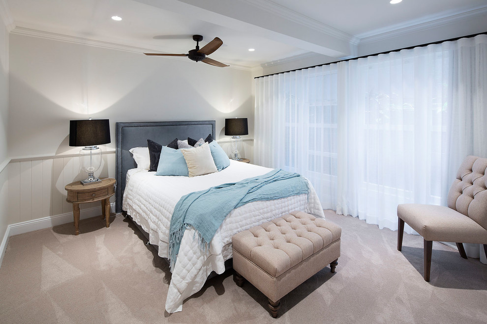 Example of a beach style carpeted and beige floor bedroom design in Other with white walls