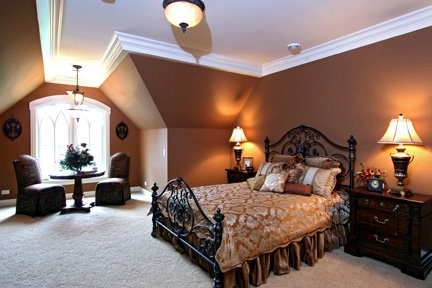 Large classic master bedroom in Chicago with brown walls, carpet and no fireplace.