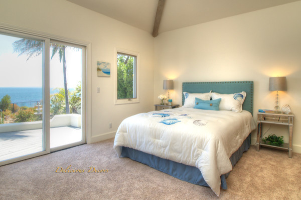 Beach style bedroom in Santa Barbara with carpet.