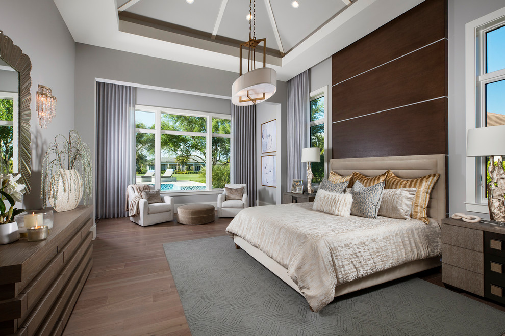 Example of a tuscan master light wood floor bedroom design in Other with gray walls and no fireplace