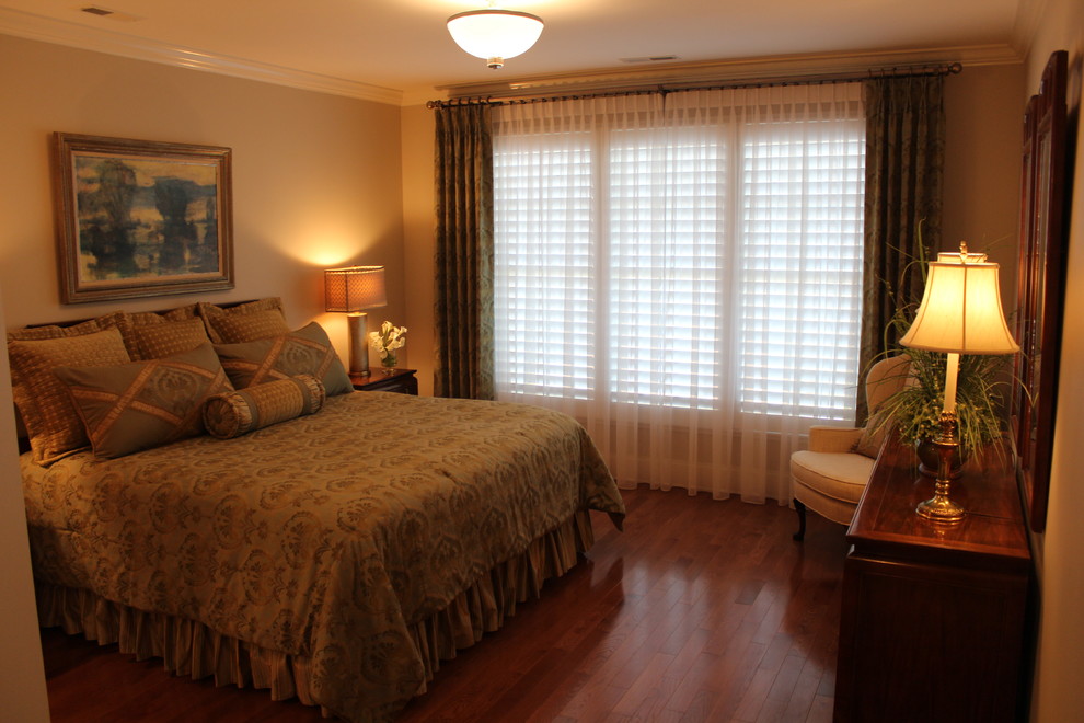 This is an example of a large classic master bedroom in Other with beige walls, light hardwood flooring and no fireplace.