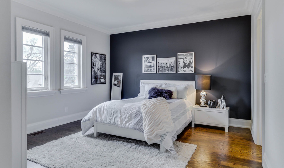 Photo of a medium sized modern guest and grey and brown bedroom in Toronto with medium hardwood flooring, grey walls, no fireplace and brown floors.