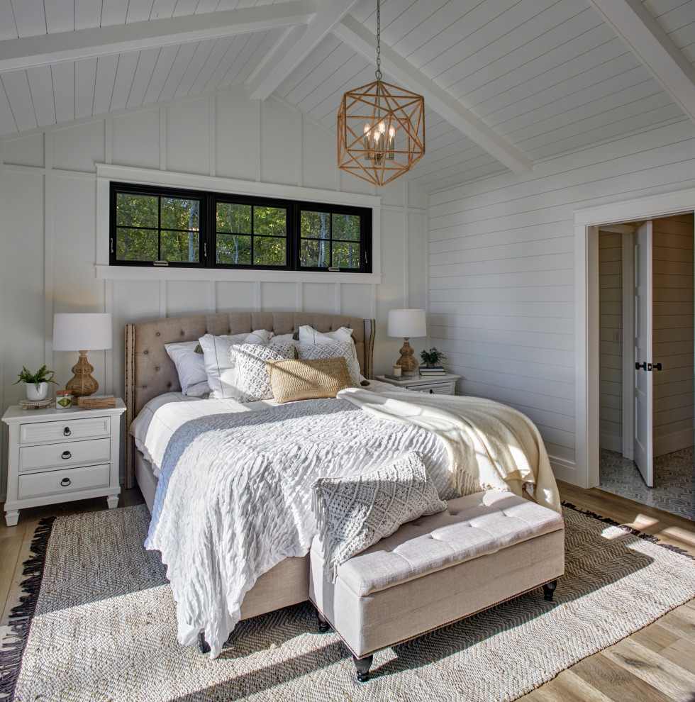 Bedroom - large coastal master light wood floor bedroom idea in Other with white walls