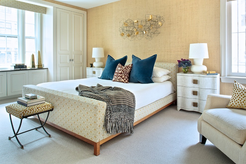 Photo of a traditional master bedroom in New York with beige walls and carpet.