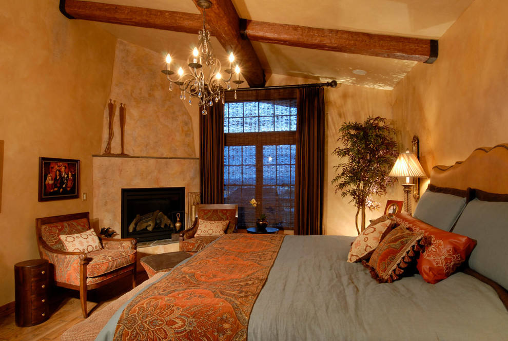 Design ideas for a mediterranean bedroom in Denver with a corner fireplace.