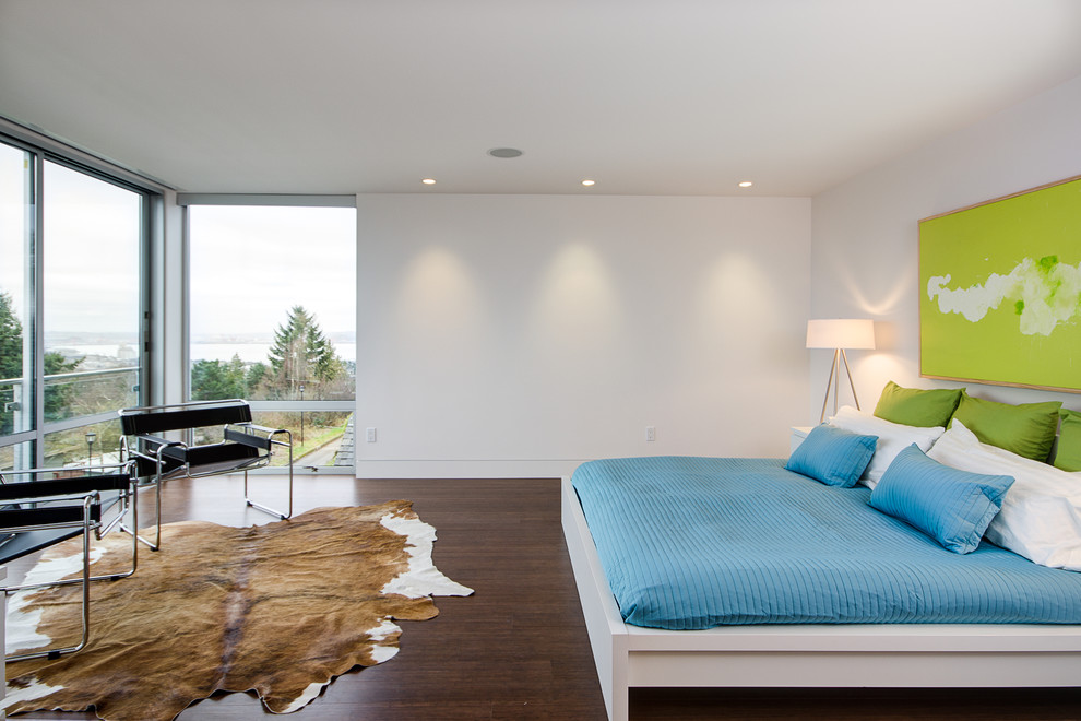 Design ideas for a modern master bedroom in Seattle with white walls and dark hardwood flooring.
