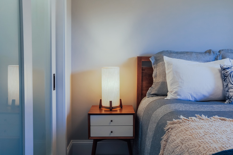 Design ideas for a small traditional guest bedroom in Denver with grey walls, medium hardwood flooring and brown floors.