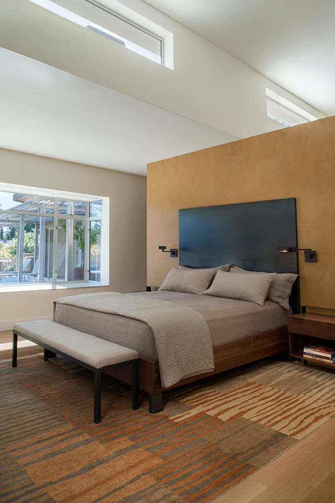 Design ideas for a large modern master bedroom in San Francisco with light hardwood flooring.