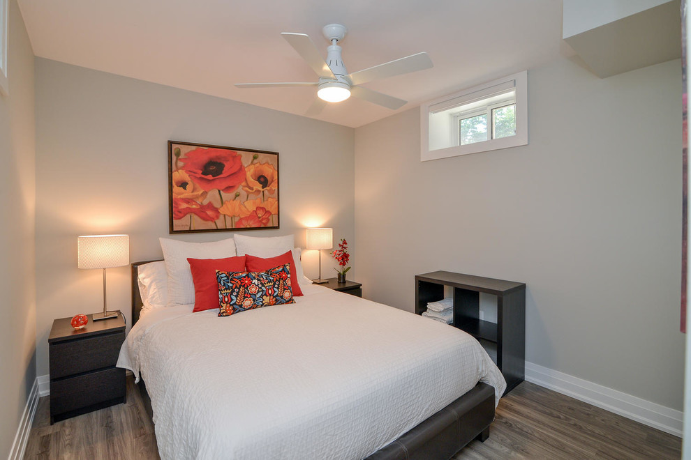 Photo of a medium sized contemporary guest bedroom in Other with grey walls, medium hardwood flooring, no fireplace and grey floors.