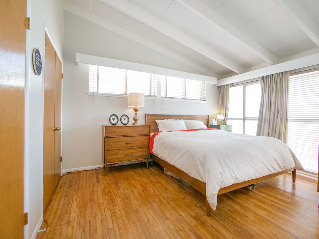 Mid-sized 1950s master light wood floor bedroom photo in Orange County with white walls