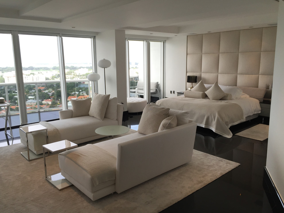 Design ideas for a large modern master bedroom in Miami with beige walls and marble flooring.