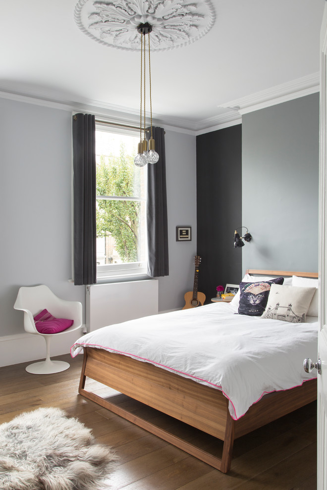 This is an example of a contemporary grey and pink bedroom in London.