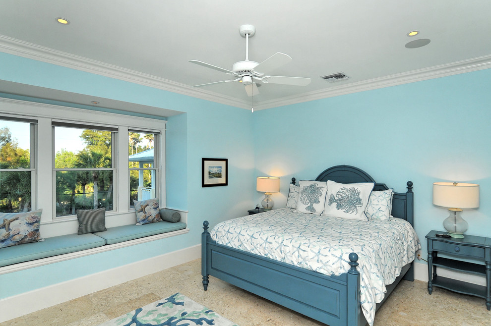 Medium sized beach style guest bedroom in Other with blue walls and multi-coloured floors.