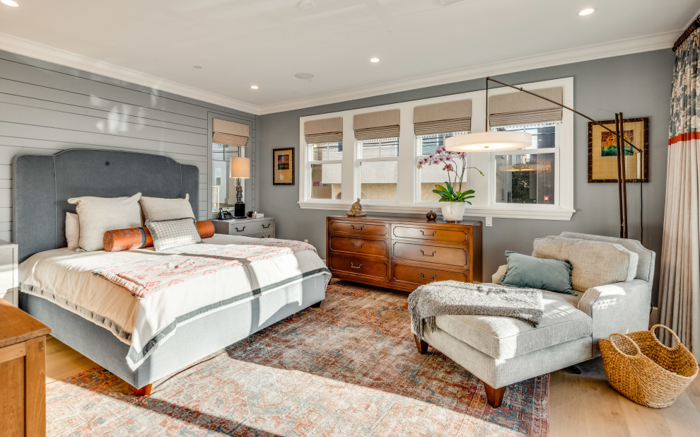 Inspiration for a transitional light wood floor, beige floor and shiplap wall bedroom remodel in Los Angeles with gray walls