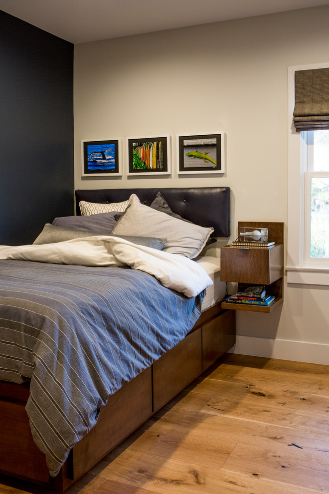 This is an example of a medium sized contemporary guest bedroom in Los Angeles with blue walls and light hardwood flooring.