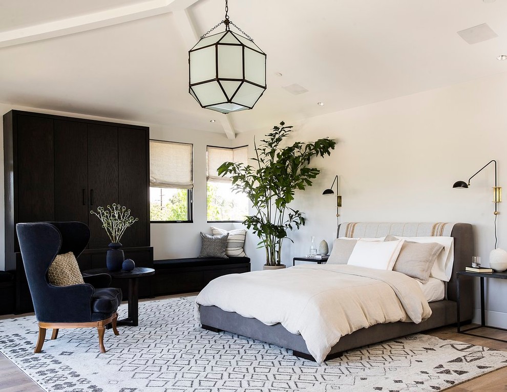 Bedroom - contemporary medium tone wood floor bedroom idea in Los Angeles with white walls