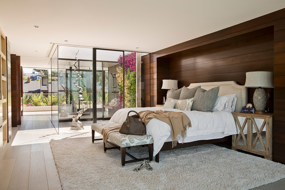 Imagen de dormitorio principal costero extra grande con paredes marrones y suelo de madera clara