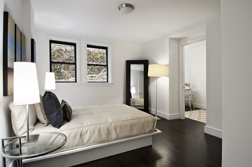 Bedroom - contemporary dark wood floor and brown floor bedroom idea in New York with white walls