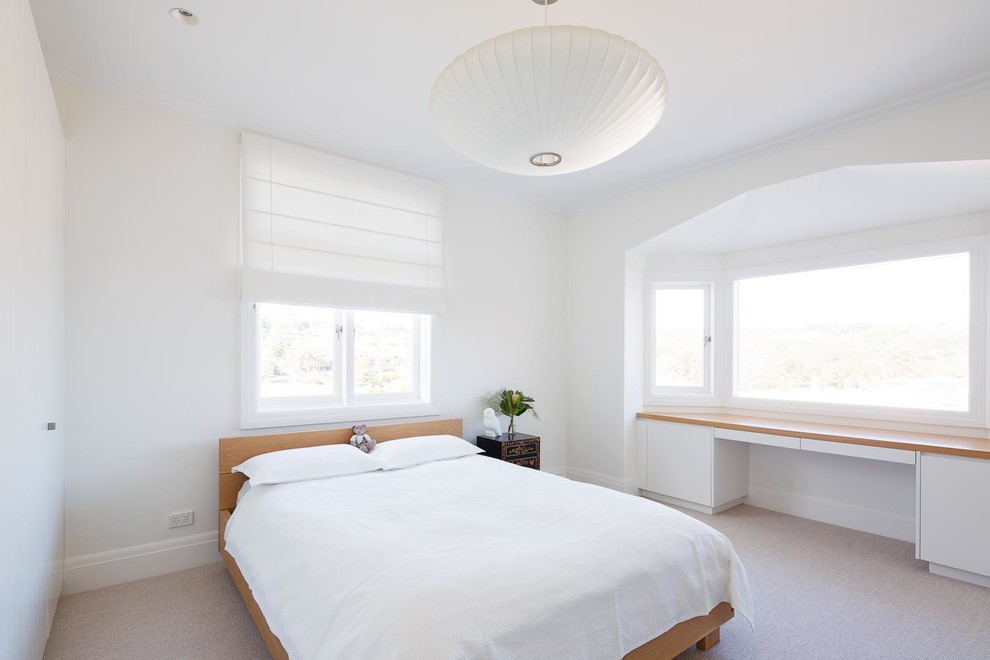 Esempio di una camera degli ospiti costiera con pareti bianche, moquette e pavimento beige