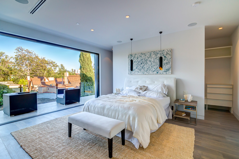 Example of a trendy dark wood floor bedroom design in Los Angeles with white walls