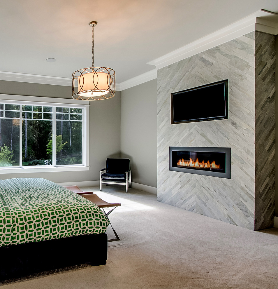 На фото: хозяйская спальня в классическом стиле с серыми стенами, ковровым покрытием, горизонтальным камином, фасадом камина из плитки и серым полом с