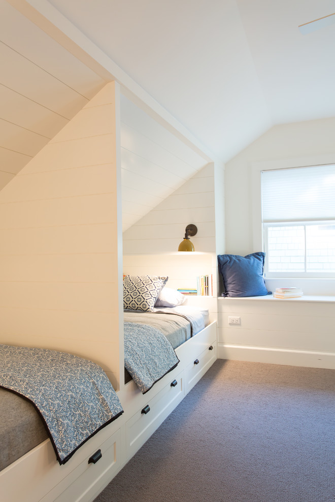 This is an example of a farmhouse guest bedroom in New York with white walls and carpet.