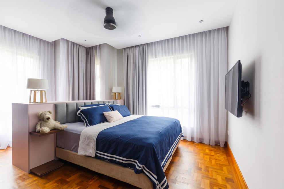 Inspiration for a contemporary bedroom in Singapore with white walls, medium hardwood flooring and brown floors.