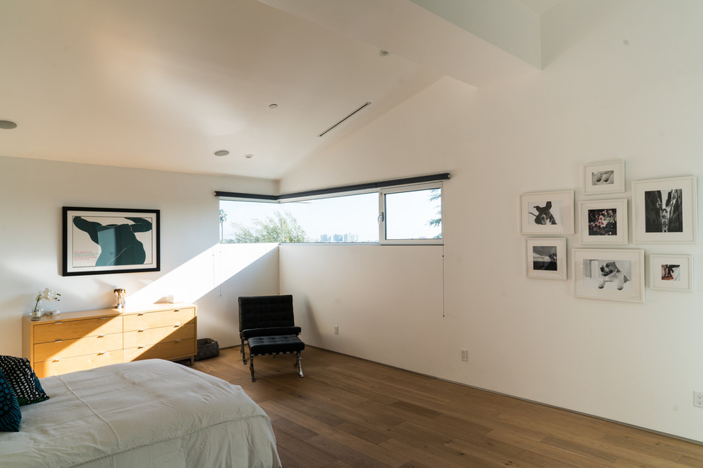 Ejemplo de dormitorio principal marinero grande con paredes blancas, suelo de madera clara y suelo marrón