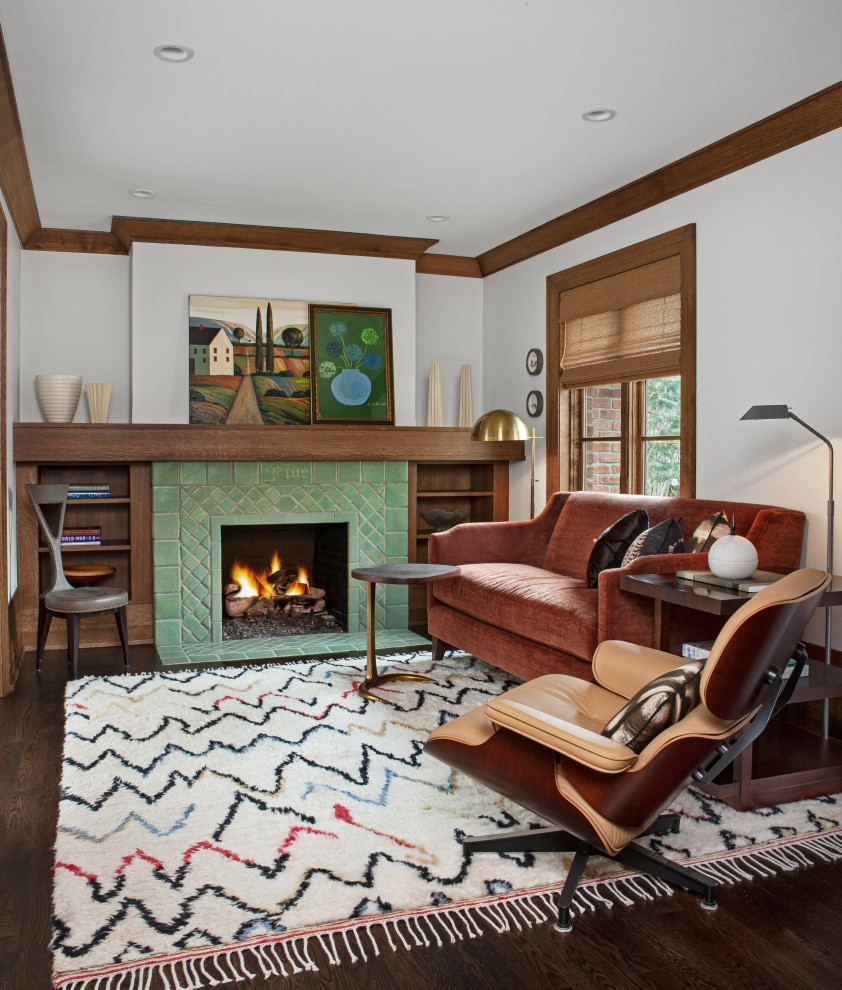 Large retro master bedroom in Detroit with white walls, dark hardwood flooring, a standard fireplace, a tiled fireplace surround and brown floors.