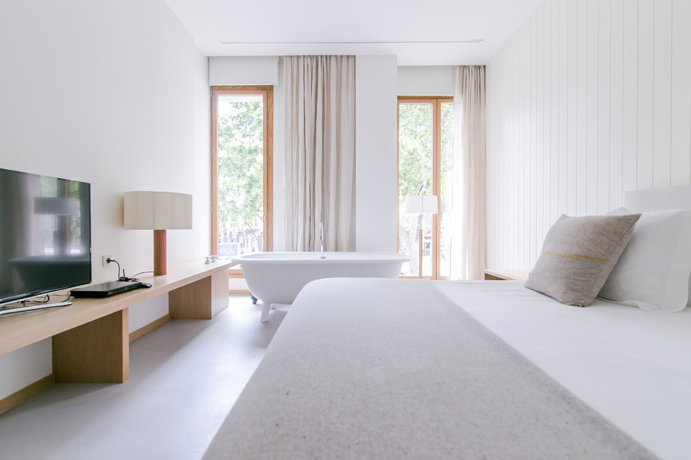 Photo of a large scandi master bedroom in Barcelona with white walls and no fireplace.