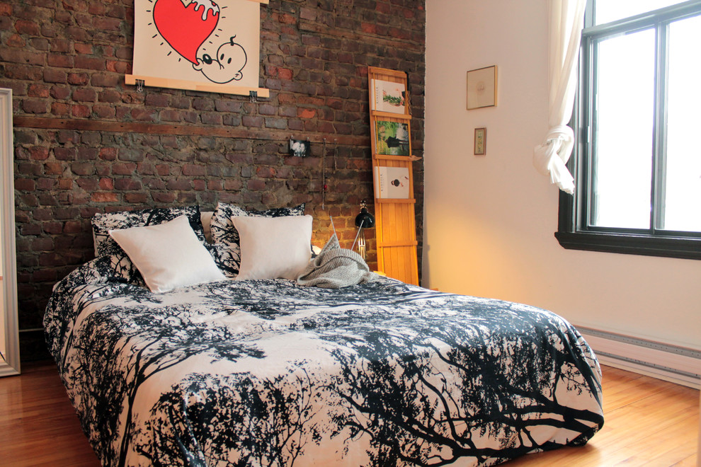 Example of an eclectic medium tone wood floor bedroom design in Montreal with white walls