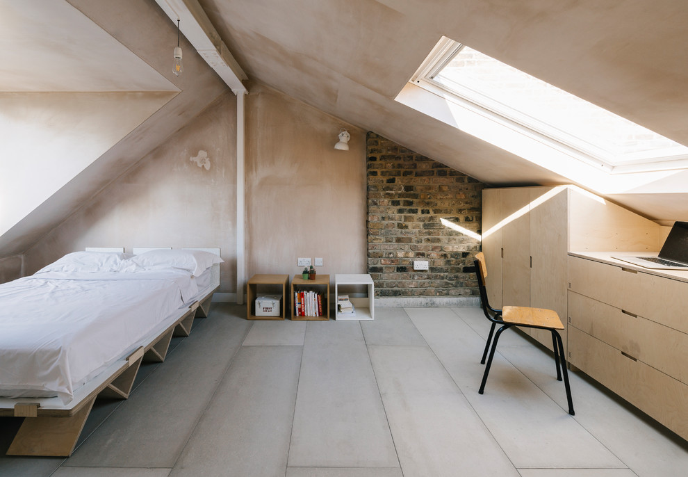 Inspiration for a scandinavian guest loft bedroom in London with beige walls, light hardwood flooring, no fireplace and beige floors.