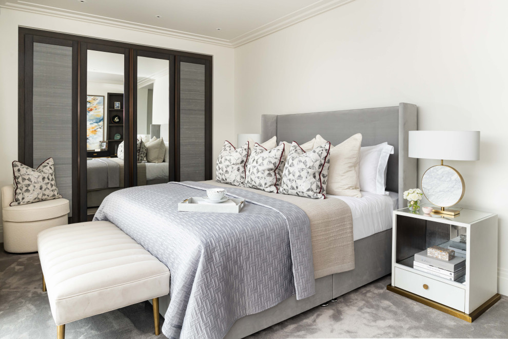 Design ideas for a contemporary bedroom in London with white walls, carpet and grey floors.