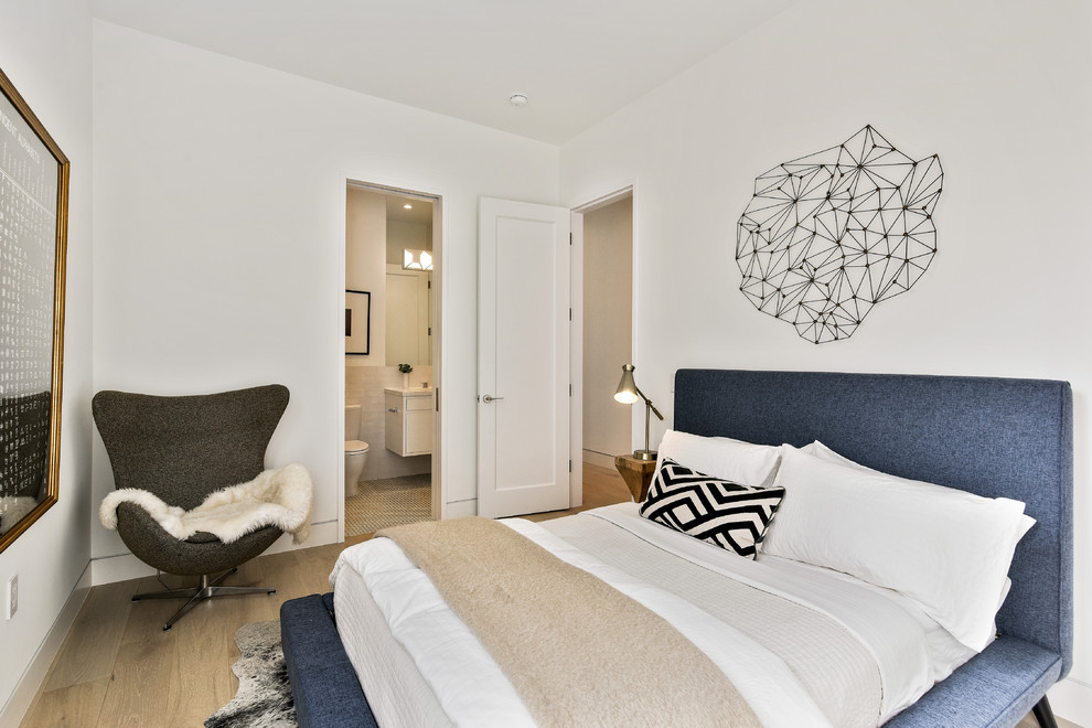 Aménagement d'une chambre d'amis contemporaine avec un mur blanc, parquet clair et un sol beige.