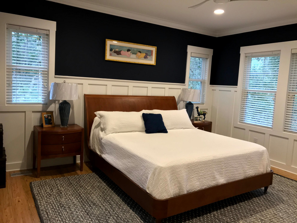 Huge master bamboo floor and brown floor bedroom photo in Other with blue walls