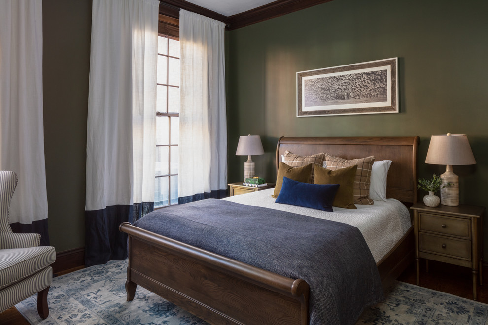 Photo of a classic bedroom in Boston with green walls, dark hardwood flooring and brown floors.