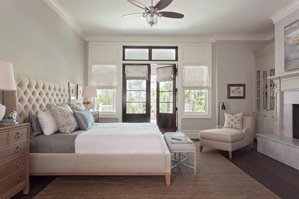 Inspiration for a large transitional master dark wood floor bedroom remodel in Charleston with gray walls, a standard fireplace and a stone fireplace