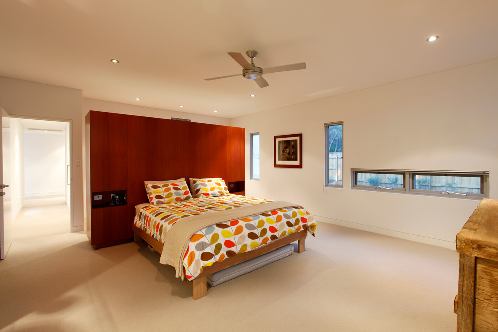 Inspiration for a large contemporary master carpeted and beige floor bedroom remodel in Perth with white walls