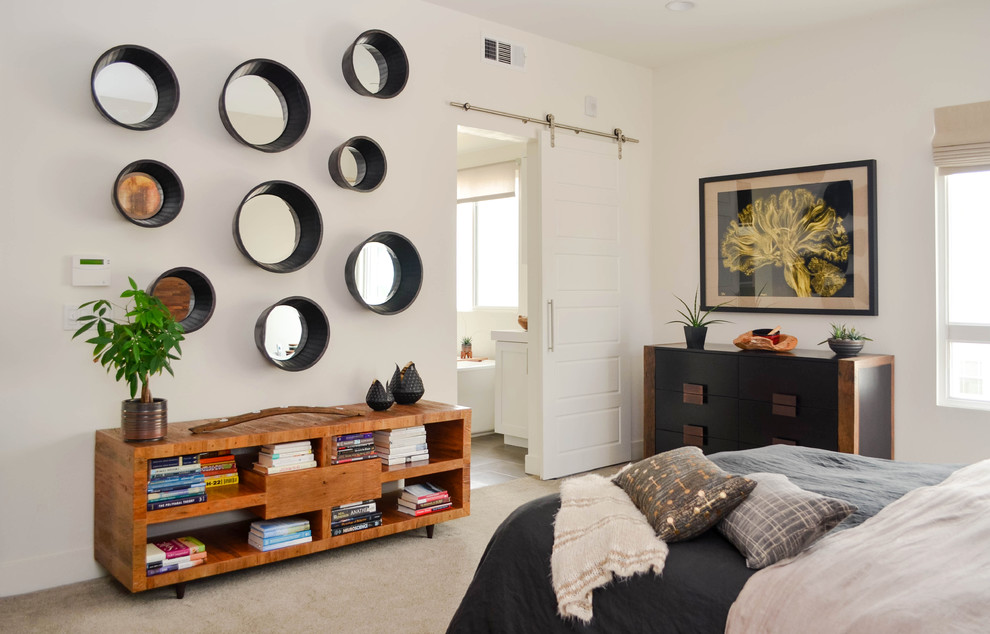 Example of a huge urban master carpeted and beige floor bedroom design in Los Angeles with white walls and no fireplace