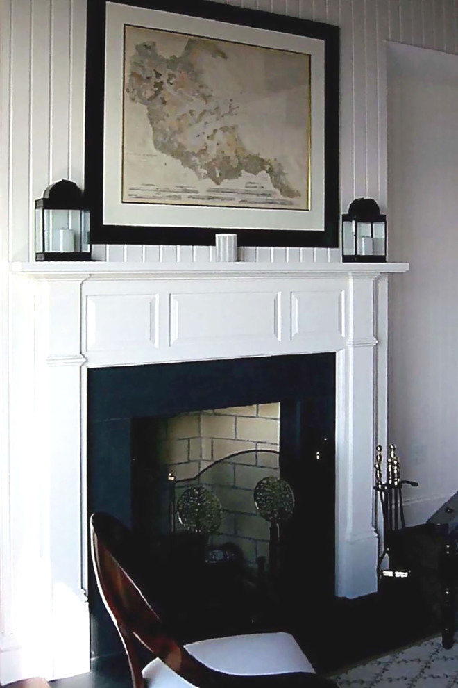 Example of a large classic dark wood floor and brown floor living room design in Boston with white walls, a standard fireplace and a stone fireplace