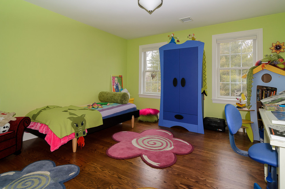 Ejemplo de dormitorio infantil ecléctico con paredes verdes, suelo de madera en tonos medios y suelo marrón