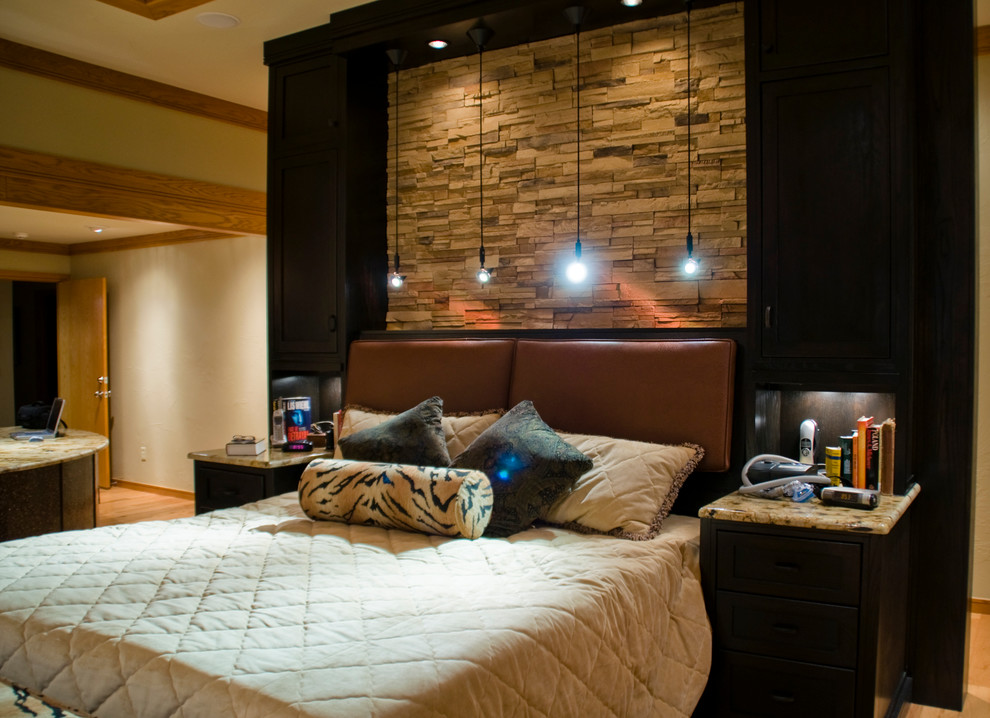 Design ideas for a large classic master bedroom in Oklahoma City with beige walls and light hardwood flooring.