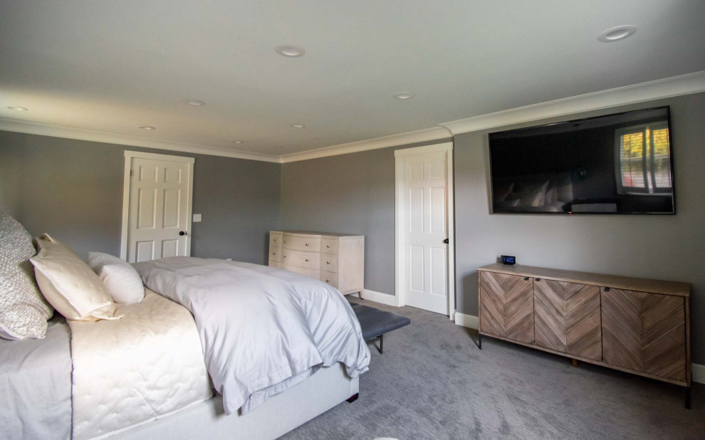 Example of a large minimalist master carpeted and gray floor bedroom design in Seattle with gray walls