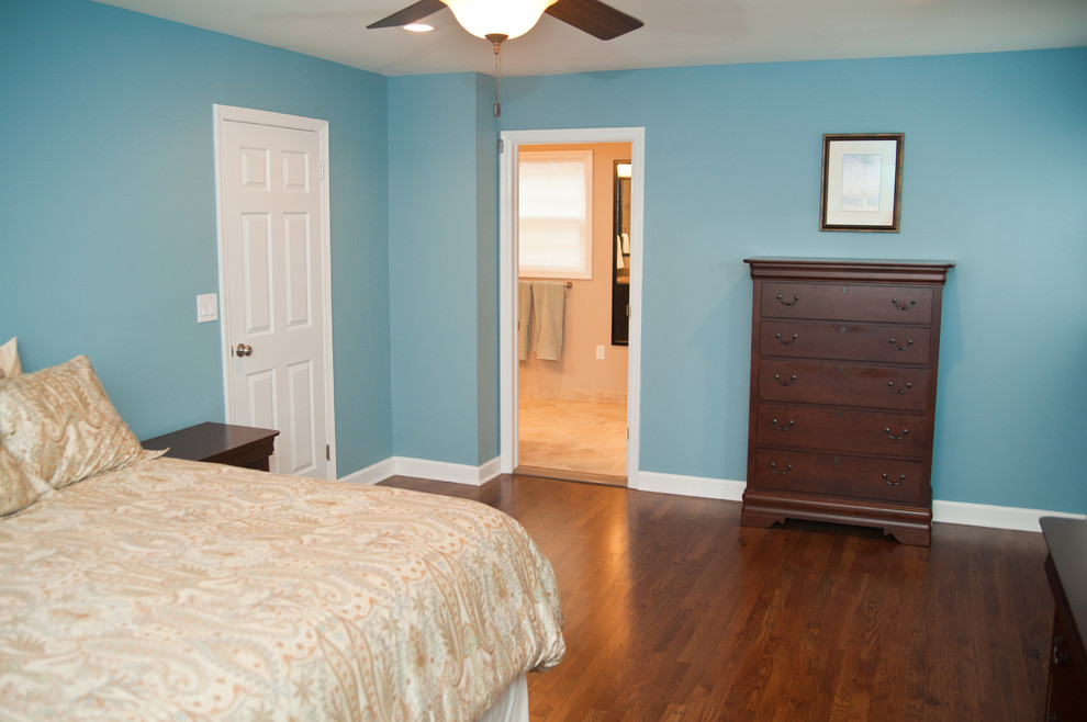 Mid-sized elegant guest dark wood floor bedroom photo in New York with blue walls and no fireplace