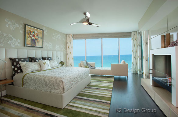 Example of a huge trendy master dark wood floor bedroom design in Miami with multicolored walls and a standard fireplace