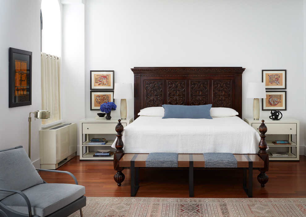 This is an example of a medium sized contemporary master bedroom in New York with white walls, medium hardwood flooring and brown floors.