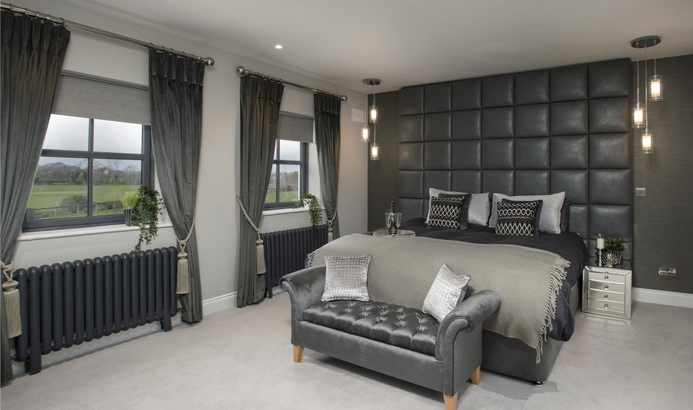 Photo of a large contemporary master bedroom in Dublin with grey walls, carpet and grey floors.
