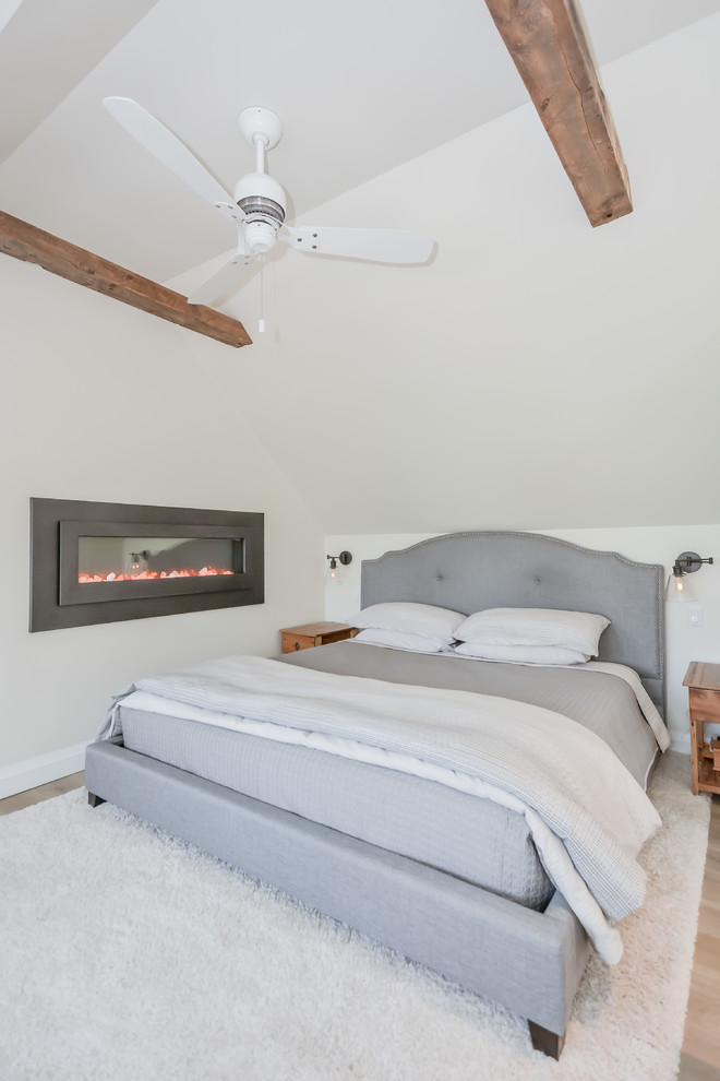 This is an example of a farmhouse mezzanine bedroom in Other with beige walls, ceramic flooring, a ribbon fireplace and grey floors.